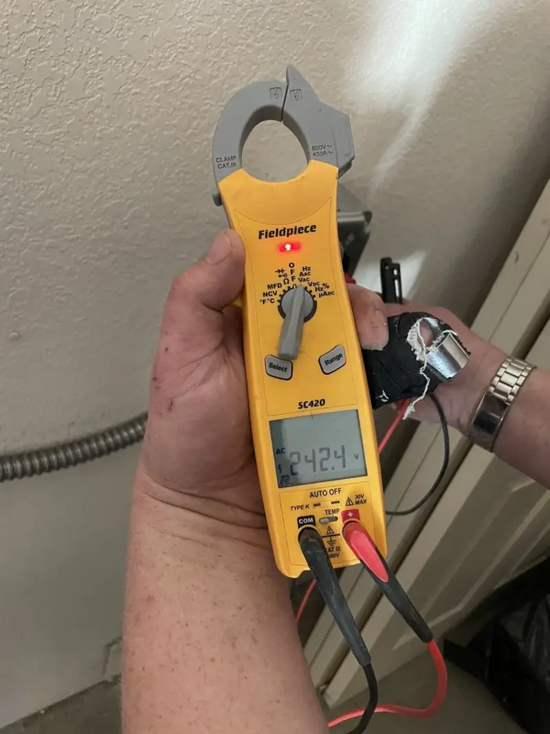 Voltage testing with clamp meter during Outlet Installation in West Seneca